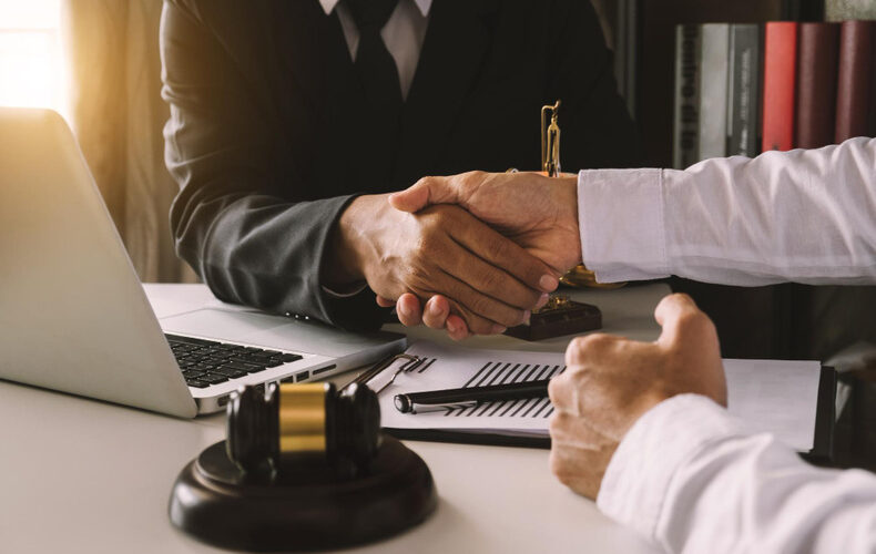 Two people shaking hands with each other